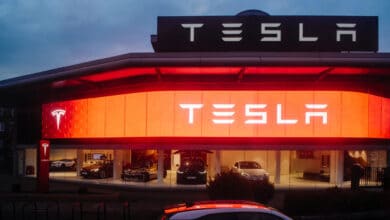 Tesla motors showroom with cars inside and illuminated logo bran