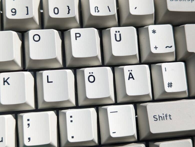 The font on non-QWERTY keycaps differs from the rest of the keycaps.