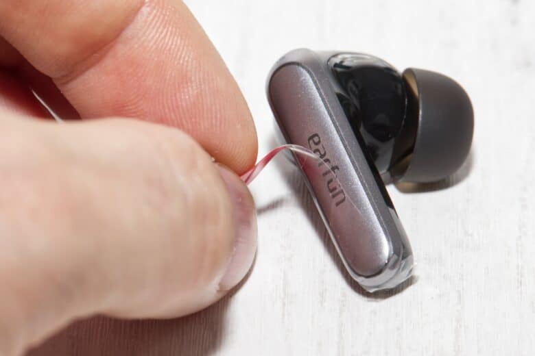 Protective film is removed from in-ear headphones